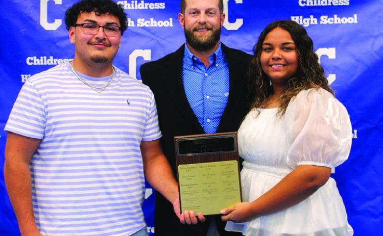 Head powerlifting coach Matthew Olson, center, awards Lady Cat Powerlifting Most Valuable Player (MVP) Rebekkah Gorman, right, and Bobcat Powerlifting MVP Adrian Macias, left.