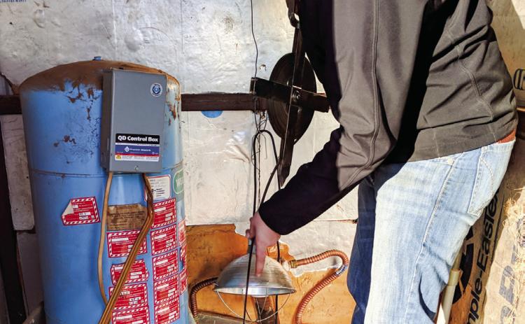 Mesquite Groundwater Conservation District staff measures water levels of an area well. Courtesy Photo