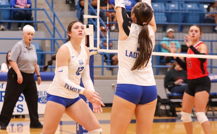 Childress’ Sara Davis sets the ball for middle blocker De’Edra Miller in the Lady Cats’ 3-1 win over the Fort Elliott Lady Cougars Friday, Sept. 5 in Childress. Childress High School Yearbook