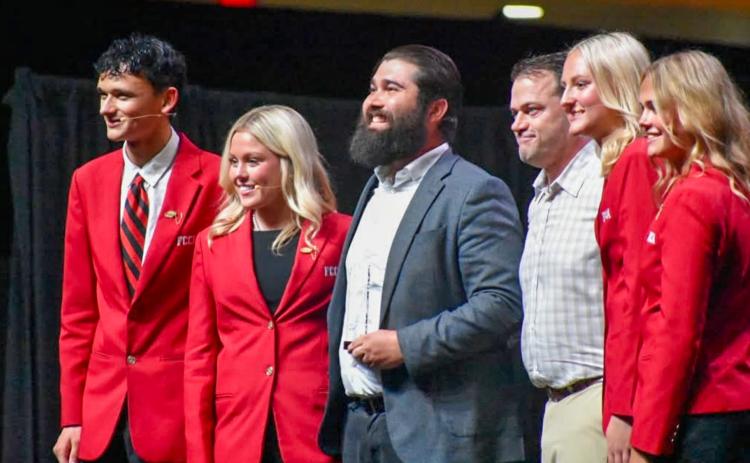 Childress High School Family, Career and Community Leaders of America (FCCLA) Adviser Jeffrey Collins, center, is awarded the Safe Roads Challenge Adviser Model of Excellence in Traffic Safety Award at the FCCLA National Leadership Conference Opening Session in Washington, D.C. CHILDRESS FCCLA