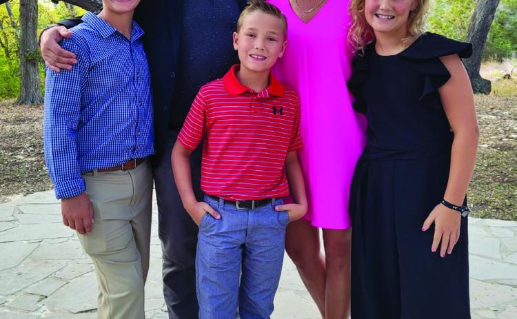 Luke and Amy Inman embrace their children, Lawson, 12, Jack, 9, and Ava Kate, 10, at a recent friends’ wedding in Austin. Amy received her cancer diagnosis in 2016 with her children 7, 5 and 3-years-old. She described this as probably being the hardest part, and she applauds her and Luke’s great parents, family and friends that continue to help them. Courtesy Photo