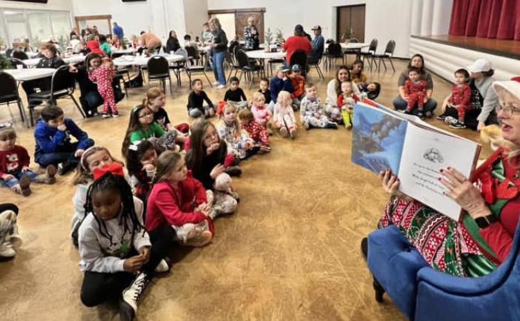 Youngsters in pajama attire gather around Mrs. Claus to hear Christmas stories during the Collingsworth County Home Delivered Meals fundraiser event Saturday morning, Dec. 9 at the Senior Community Café. Courtesy Photos
