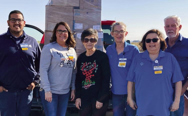 Walmart Supercenter donates clothing and shoes to Childress County Christmas Sharing (CCCS), a nonprofit organization which aids local families in need of assistance during the holiday season, giving them food, clothing and toys. Raymond McGee and Jimmy Smith picked up the items, which were accepted by CCCS Board Secretary and Treasurer Raenell Smith, center. Photo Courtesy of Childress County Christmas Sharing