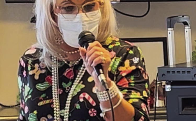 Vocalist Melissa Kiker sings 16 Christmas selections at Wellington Care Center Sunday afternoon, Dec. 11. She always considers entertaining the residents a blessing. Her husband, Lon Kiker, assisted her with the music, and her daughter, Grace Kiker, attended as well. Courtesy Photo