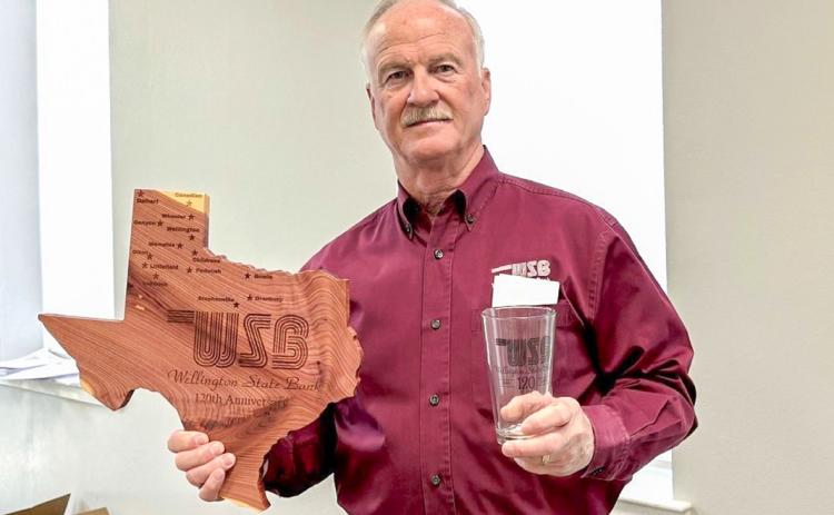 Wellington State Bank President and Chief Executive Officer (CEO) Richard Sims displays commemorative gifts given to stockholders in celebration of the bank’s 120th anniversary, including Texas-shaped cedar plaques engraved with each Wellington State Bank location and drinking glasses, each featuring the 120th anniversary mark. WELLINGTON STATE BANK