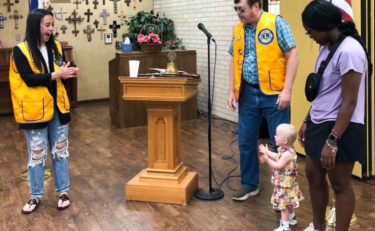 Wellington Lions Sweetheart Summer Owens, 18, and guest Kaydence Mixon, 2, with Lion Jayla Kilgore, celebrate June birthdays as Lion Jeff Pastor leads in singing “Happy Birthday” to open the June 19 meeting. The Red River Sun/Bev Odom