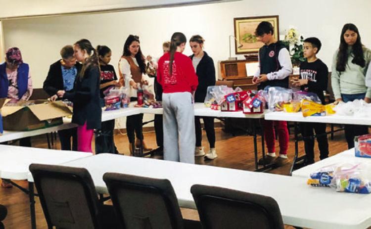 Students assist Wellington Lions Club with senior snack packs