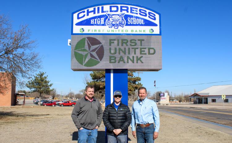Childress Independent School District (ISD) Superintendent Mark Dykes, right, thanks First United Bank Vice President Taylor Thornton, left, and First United Bank Assistant Vice President and Childress Branch Manager Alabama Bohannon, middle, for the new digital marquee, located on the Childress High School campus. The Red River Sun/Elizabeth Tanner
