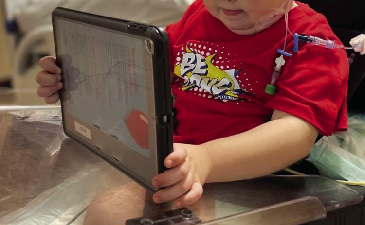 Only a few days after receiving his new kidney, five-yearold Clive William Downing plays on his iPad at the Dallas hospital. For photos of Clive’s Fearless Warrior factions, see page 8B. Courtesy Photo