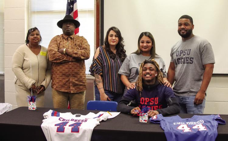 Childress’ Kobe Sims signs a National Letter of Intent to play football at the collegiate level at Oklahoma Panhandle State University, located in Goodwell, Okla., Monday, Feb. 3 in the Childress High School Media Center. Childress High School Yearbook Staff
