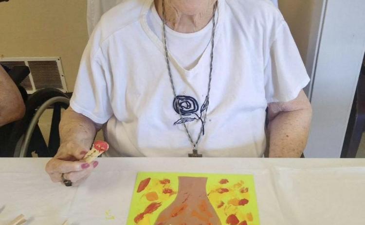 Despite triple digit temperatures, Memphis Convalescent Center residents got a taste of autumn Thursday, Aug. 17, painting fall trees. Only a week away, the official start of autumn begins Friday, Sept. 1. Photo Courtesy of Memphis Convalescent Center