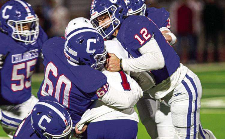 Childress’ Seth Taylor (12), (3), (60), (55) and (25) take down Coahoma’s Reagan Chapman (1) during the Bobcat’s Bi-District Championship win Friday, Nov. 11. The Red River Sun/Nicole Dill