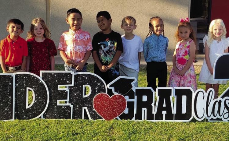 On their way to their kindergarten graduation, Kacy Cabbell’s Wellington Elementary School students admire the yardcard sign in their honor. From left: Jonah Akemon, Jayden Alvarado, Drake Barlow, Dallas Castor, Kenleigh Cummings, Yahir Estrada, Diego Gonzales, Andrew Hughs, Alias Jones, Brantley Kemp, Blake Lemons, Ezekiel Rivera, Evelyn Sanchez, Whitney Souder. Wellington Elementary Sparklers
