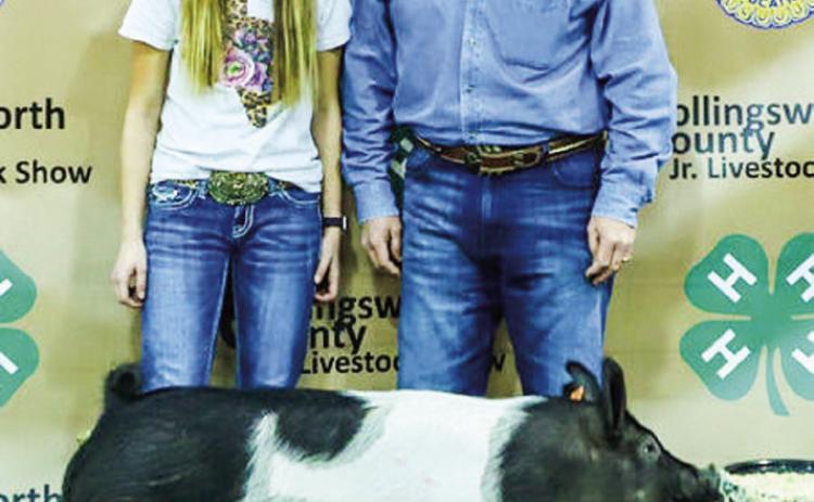 At the Saturday, Jan. 14 Collingsworth County Livestock Show Premium Sale, Maci Brewer displays her second-place class 1 cross swine with buyer Boedecker Flying Service, represented by Dale Dunlap. Molly Sims Photography