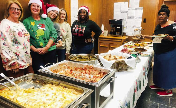 Wellington State Bank staff and caterers greet guests during the Thursday, Dec. 5 holiday open house at Wellington State Bank. Bertie Fannie served chicken alfredo, lasagna, green beans and garlic bread. Cold-cut appetizers, banana bread, Veronica cookies and fudge complemented the main course. From left, Renee Hanna, Bertie Fannie’s Sarah Cook and Courtney Bristol, Bonnie Clark, Brittany Massey and guest Renee Mathis. The Red River Sun/Bev Odom