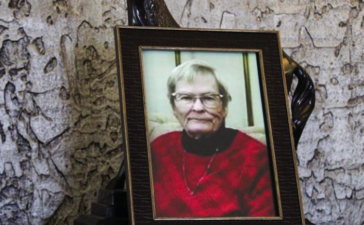 Photos of the late Orvilla Evans are scattered throughout the Memphis Housing Authority lobby during a memorial bench dedication service Thursday, Feb. 27. The Red River Sun/Elizabeth Tanner