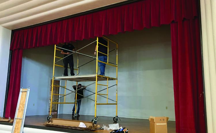 In anticipation of the opening of the new Wellington Senior Citizens Center, located in the renovated Bura Handley Community Building, the stage floor has been refinished, the walls and rafters painted and the new Skyrocket-red curtains installed. Funded by the Wellington Lions Club, the stage lighting will be installed next week. Photo by Neal Odom