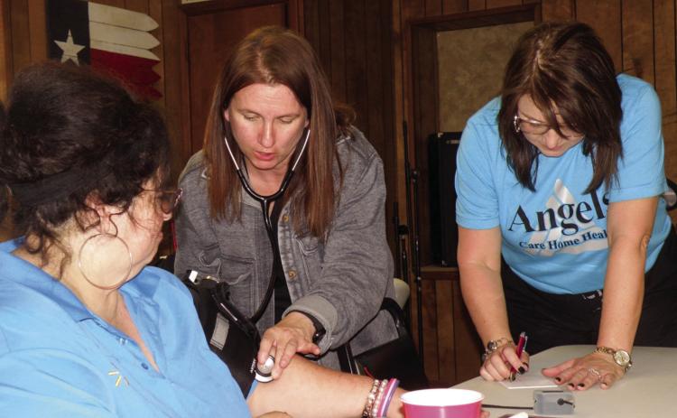 Michelle Hibbs, left, recently receives a blood pressure check at the Childress Senior Citizens Center. Making their monthly visit to the center are Angels Care Home Health of Vernon Branch Manager Kristen Horn, RN, center, and Account Executive Melissa Conner, right. Both assisted with the weekly noontime meal and explained the services Angel Care Home Health offers to assist the elderly in remaining in their own homes. Photo by Grace Holman