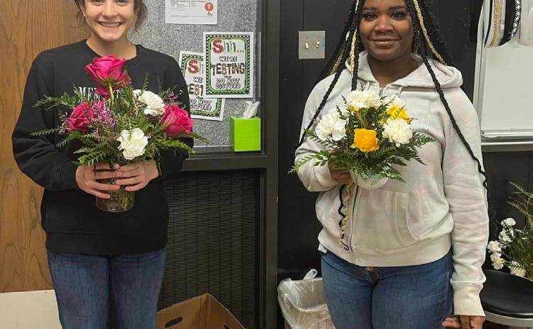 Floral design students create multi-flower bud vases, mug arrangements
