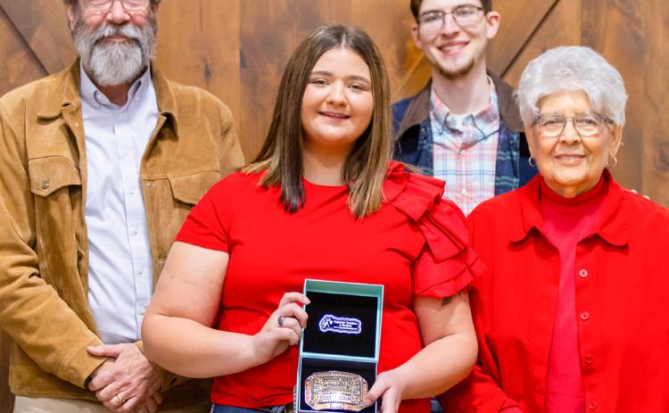 Wellington High School senior Jacy Lampe receives the Herdsmen Award in honor of the late Don Reeves during the Collingsworth County Livestock Association’s dinner and sale Saturday evening, Jan. 17 at the Bura Handley Community Center. From left: Wes Reeves, Jacy Lampe, John Reeves, Katherine Reeves. Uplift Imaging