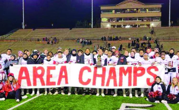 Following a 48-0 Area Championship win over the Sudan Hornets, the Wellington Skyrockets gather for a moment of glory before preparing for the next opponent. Photo Courtesy of Wellington High School