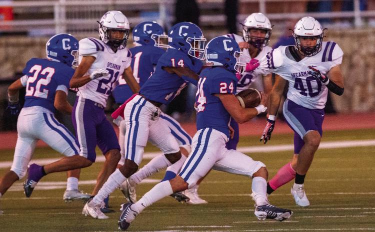 Childress’ Nick McMinn gains yardage for the Bobcats, while Lamont Nickleberry (14), Mark Willis (21) and Aiden Allen (22) block out the Spearman Lynx defense during Childress’ 41-7 win Friday, Oct. 21 at Fair Park Stadium. The Red River Sun/Nicole Dill