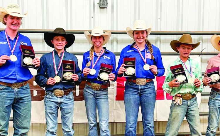 Region 1 members Cutter Bruce, of Childress, left, Hazen Lamb, of Borger, Avery Armstrong, of Borger, Colee Cox, of Tell, Rhyder Rosipal, of Miami, and Slayde Stalls, of McLean, receive their Team Texas World Championship buckles and medals at the Region 1 Texas Junior High Rodeo Saturday, Oct. 22. The Red River Sun/Elizabeth Tanner