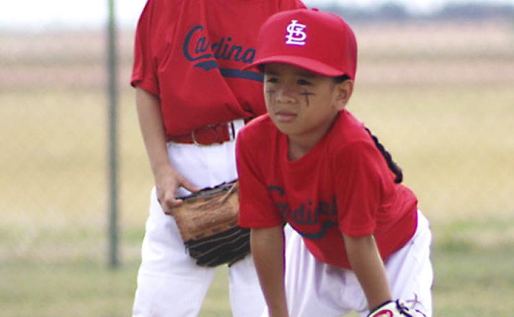 Coach Pitch Division Cardinal team members, first grader Alejandro Salinas backed up by second grader Damien Page, get in position for game action last Saturday. SHAUNA SALINAS / RED RIVER SUN