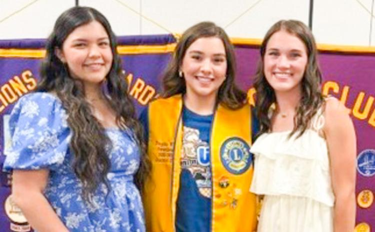 Wellington High School (WHS) junior Kaycee Martinez, left, will reign as Wellington Lions Club’s new 2026-2027 Sweetheart. Members selected Martinez during the Monday, May 4 meeting, where junior Maggie Tillman, right, also competed for the honor. Each candidate addressed the Lions and described their involvement in school activities and passion for community service. The 2025-2026 Sweetheart, Treylea Wiebe, congratulates both candidates. BEV ODOM/THE GREENBELT INTREPID