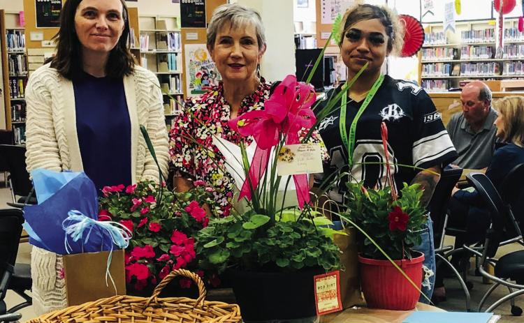 Surrounded by Library Aids Susie Klassen, left, and Layla Williams, right, Librarian Vicki Decker serves as guest of honor at a reception to mark her 37 years of service to Collingsworth Public Library the afternoon of Wednesday, May 14. The Red River Sun/Bev Odom
