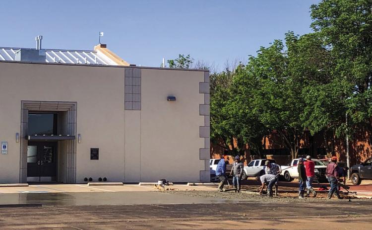 Contractors smooth wet cement Monday, May 1 to extend the parking area on the north side of Wellington Senior Citizens Center, 906 Amarillo St. The Red River Sun/Bev Odom