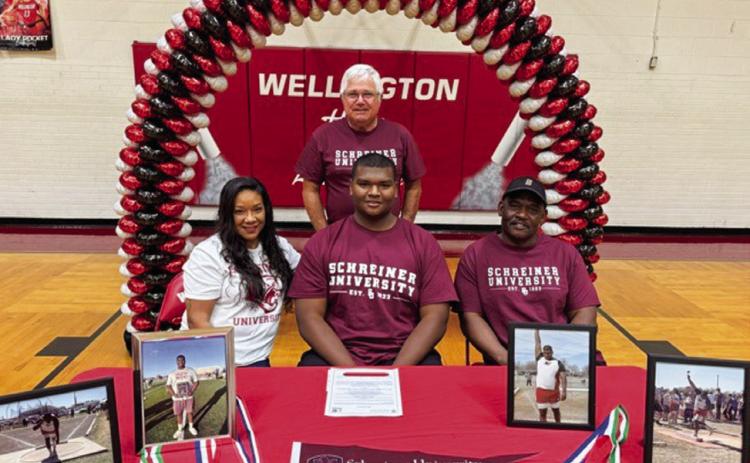 Wellington High School senior Jovani Munn signs a National Letter of Intent to continue his track career at Kerrville’s Schreiner University Friday, May 9. From left: mother and step-father Hope and John O’Rear; Munn; father Joe Bill Munn. Wellington High School