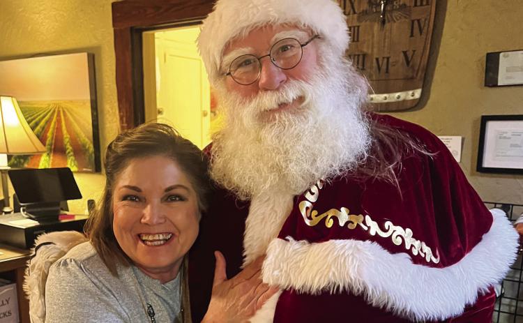 Beverly Smith visits with Santa Claus at The 501 Winery, located in downtown Childress. The Red River Sun/Nicole Dill