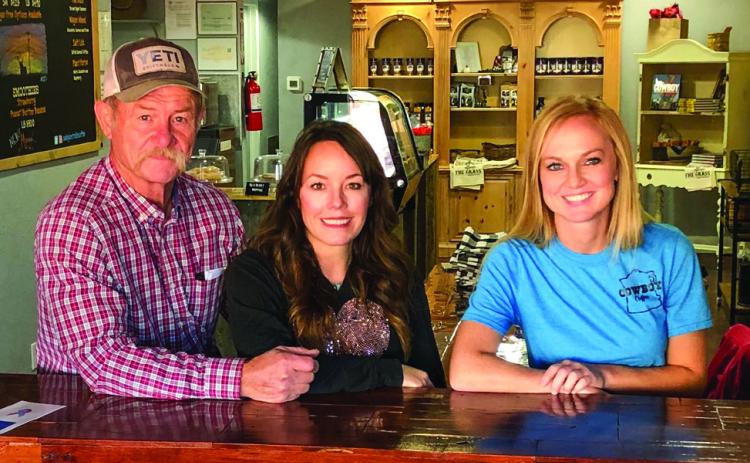 Kent and Shannon Rollins, along with Director of Operations Shari Reyna, clinch a quiet moment in their busy lives at Kent Rollins’ Cowboy Coffee shop Tuesday morning, Oct. 25 in downtown Wellington. The Red River Sun/Bev Odom