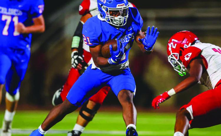 Childress’ Lucian Davis stiff arms a Friona defender during the Bobcats’ district opening win over the Chieftains Friday, Oct. 11 at Fair Park Stadium in Childress. Press Pass Sports/David Erickson