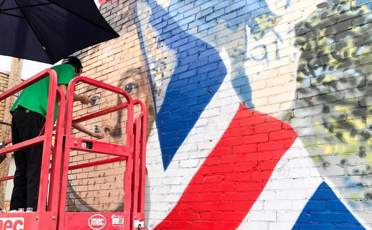 Muralist Malcom Byers adds shading to the nostrils of the Duke of Wellington with his spray paint technique Tuesday morning, Aug. 26. As he nears completion of his Wellington mural masterpiece, he lacks about a week finishing and touching up his artwork on the south side of 915 West Ave., just next to Wellington City Hall. The Red River Sun/Bev Odom