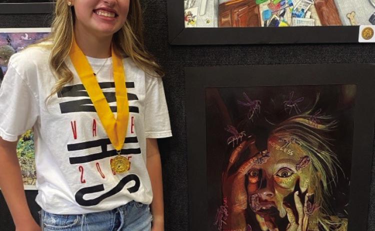 Wellington High School sophomore Elli Ouellette receives the prestigious Gold Seal at the State Visual Arts Scholastic Event (VASE) in San Marcos with her piece, Stinging Torments, which reflects the stinging impact of words that people have spoken to her. She also has a great fear of wasps. Wellington High School