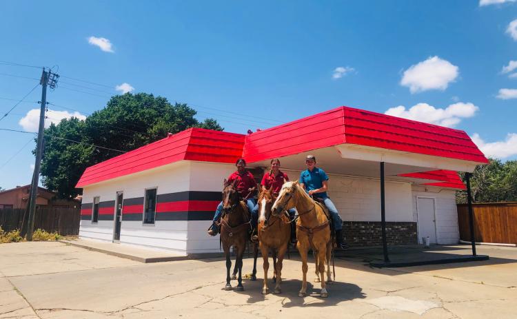 Wellington High School students Jasmin Moreno, left, Eryn Torrez and Ellie Thomas can’t pass up a My T Burger ice cream treat as they warm up their horses for the upcoming Wellington Fourth of July Rodeo. The Red River Sun/Bev Odom