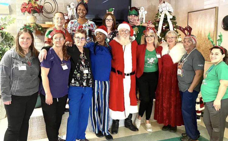 Partygoers describe Wellington Care Center’s Christmas party on Monday, Dec. 18 as a fantastic time with the residents. Finger foods, yummy desserts, generous gifts and a special visit from Santa and Mrs. Claus captured everyone’s attention. “Thanks to our community that donated to our residents,” said Administrator Nikki Hathaway. “You made this wonderful day possible!” Staff delayed the departure of Santa and Mrs. Claus for a group photo to savor the essence of the special day. Courtesy Photo