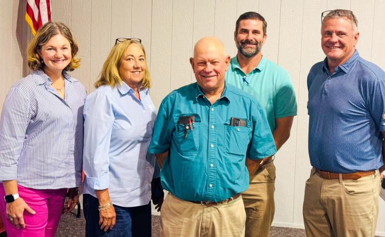 Tri-County Co-Op Gin Manager Jeff Camp, center, expresses his appreciation to the special guests who traveled to Dodson for the Thursday, Aug. 21 annual meeting. From left: Lauren Decker, of Stamford, Rolling Plains Cotton Growers; Shelly Henrich, of Lubbock, Cotton Board; Chad Levings, of Altus, Triangle Insurance; Matt Monroe, of Altus, Plains Cotton Cooperative Association. Jim Ellis