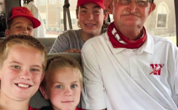 Skyrocket managers Jax Heflin, Jake Anderson, Major Brown and Caleb Strickland gather with “Coach Mike” for a photo before heading out to a football game in 2020. See page 9A for his full obituary. Photo Courtesy of Colby Anderson