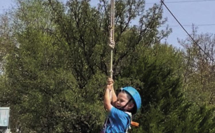 Three-year-old Will Patterson takes a turn on the zipline during the Collingsworth County 4-H Enrollment Party Saturday, Sept. 10 at Panfork Baptist Camp. Other activities included swimming, fishing, playing volleyball and eating hotdogs.
