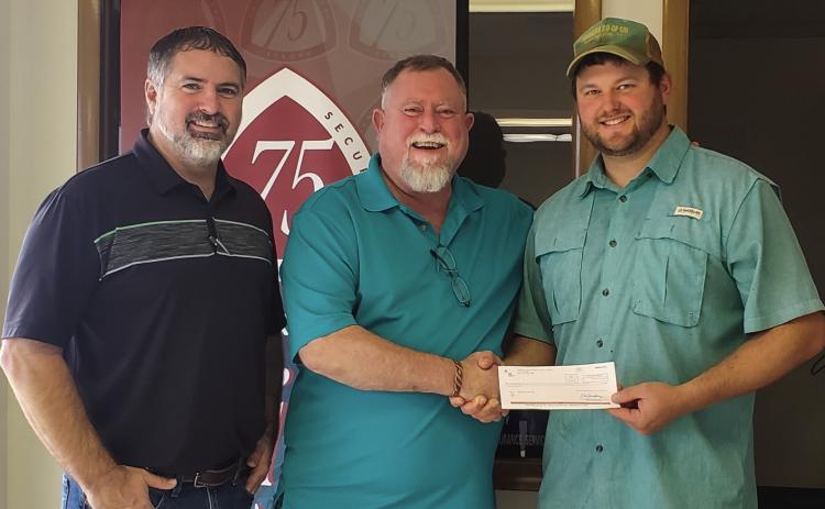 Representing Samnorwood Volunteer Fire Department, volunteer Tucker Conner, right, accepts a donation from Texas Farm Bureau Insurance, presented by Brandon Ward and Durk Green. Courtesy Photo