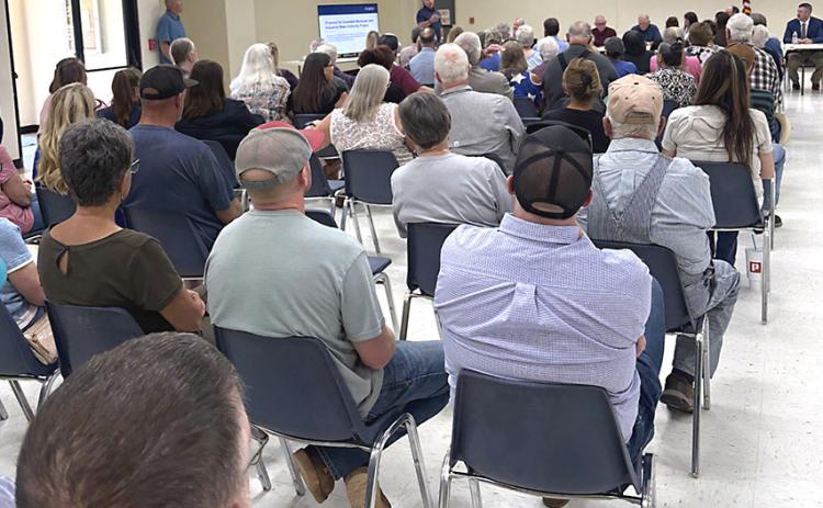 Residents listen to a Lancium representative discuss a plan to bring new water to the Greenbelt system Tuesday. INTREPID PHOTO / AARON RAMOS