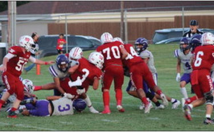 Skyrocket Gatlin Guy (3) runs the ball down field as Caleb Strickland (50), Israel Acosta (52), Tryston O’Rear (70), Ethan Nevarez (44) and Dakota Marshall (6) fend off the 3A Spearman Lynx during Wellington’s 12-6 homecoming victory last Friday night, Sept. 15. The Red River Sun/Shauna Salinas
