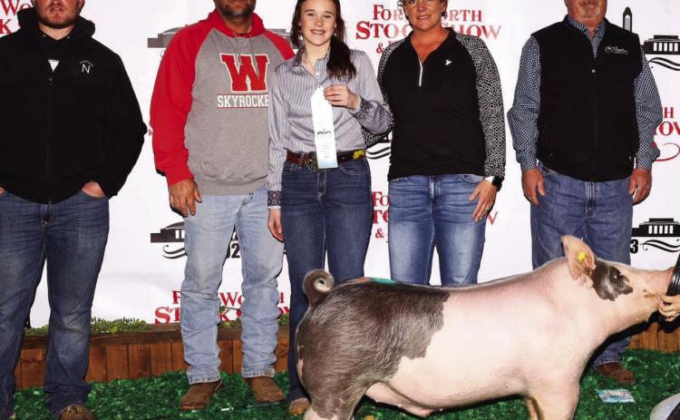 Wellington High School freshman Kenady Skelton takes 10th place with her medium weight cross swine at the Fort Worth Stock Show and Rodeo Thursday, Feb. 2. From left: Clint Newbrough, Chad Skelton, Kenady Skelton, Carrie Skelton, David Newbrough. Courtesy Photos