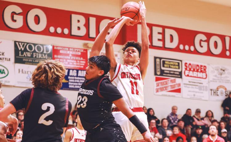 Wellington’s Bryant Tarver shoots a jumper over a Clarendon defender Friday, Jan. 19. Press Pass Sports/James Abel
