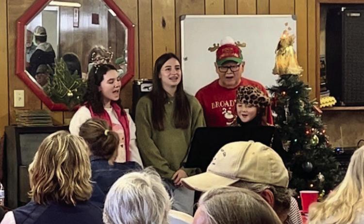 Monson Music Studio students Libby Sanford, Saylee Ochoa and Bella Blu Sanders, accompanied by Monson Music Studio instructor Gerald Monson, perform at the Childress Senior Citizens Center’s Christmas Luncheon Thursday, Dec. 19. Courtesy Photos