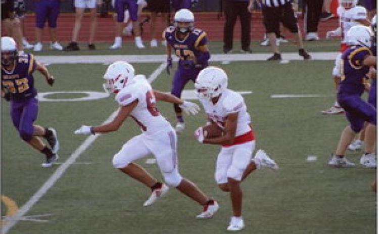 Junior varsity Skyrocket RJ Granadoz (60) blocks for ball carrier Anthony Ortiz (15) as he gains yards for the Rockets in the 32-6 win against River Road on Thursday, Sept. 8 at Powell Field. The junior varsity Rockets versus the Spearman Wildcats last Thursday, Sept. 15 was cancelled due to lighting and rain. The Red River Sun/Shauna Salinas