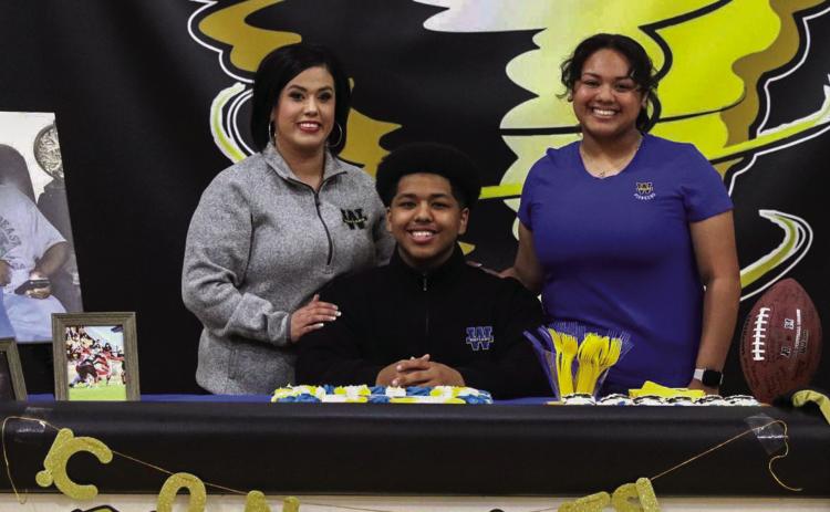Memphis High School senior Brandon Pierson signs to play collegiate-level football at Wayland Baptist University Tuesday, May 25. Through the Lens of Liz/Elizabeth Oronia